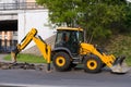 Working on the excavator pulls out of the ground old curbstone Royalty Free Stock Photo