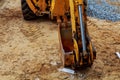 Yellow excavator loader construction site with raised bucket Royalty Free Stock Photo