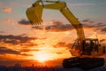 Yellow Excavator loader on sky and sunset backgrounds
