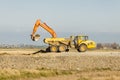 Yellow excavator loading soil on a truck at mine. Royalty Free Stock Photo