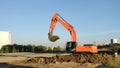 Yellow excavator machine during excavation work on construction site Royalty Free Stock Photo