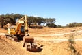 yellow excavator machine preparing soil