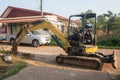 Yellow excavator machine working earth moving works at construction site Royalty Free Stock Photo
