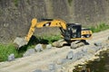 Yellow excavator machine works near Arno river shores, in Florence Royalty Free Stock Photo