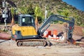 Yellow excavator performing excavation work in a construction site Royalty Free Stock Photo