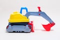 Yellow excavator plastic car on white background. Construction machinery car for digging for toy store and children. Royalty Free Stock Photo