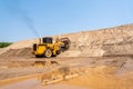Yellow Excavator at sandpit. road construction Royalty Free Stock Photo