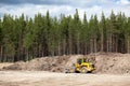 Yellow excavator in sandpit