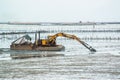 Yellow Excavator in the sea