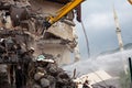 A yellow excavator is working on demolishing an old house in the city of Alanya, Turkey Royalty Free Stock Photo