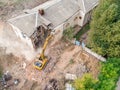 Yellow excavator working at old building destruction Royalty Free Stock Photo