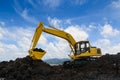 Yellow excavators are digging the soil in the construction site Royalty Free Stock Photo