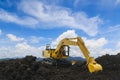 Yellow excavators are digging the soil in the construction site Royalty Free Stock Photo