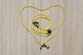 Yellow eyeglasses strap, placed in a heart shape
