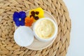 Yellow face mask banana face or eye cream, shea butter mask, mango body butter in a small white jar. Natural skin and hair care Royalty Free Stock Photo