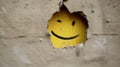a yellow face painted on a wall
