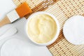 Yellow facial mask banana face cream, hair mask, body shea butter in the small white jar. Natural skin and hair concept. Royalty Free Stock Photo