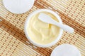 Yellow facial mask banana face cream, shea butter hair mask, body butter in the small white container. Natural skin care Royalty Free Stock Photo