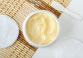 Yellow facial mask banana face cream, shea butter hair mask, body butter in a small white container. Natural skin care Royalty Free Stock Photo