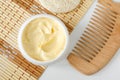 Yellow facial mask banana face cream, shea butter hair mask, body butter in the small white container. Natural skin, hair care Royalty Free Stock Photo