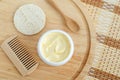 Yellow facial mask (banana face cream  shea butter hair mask  body butter) in the small white container. Royalty Free Stock Photo