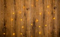 Yellow fairy lights on a wooden wall