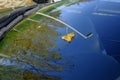 Yellow fallen leaf on the windshield with street reflections on the window. Autumn/fall background.