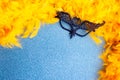 Yellow feathers and masquerade mask copy space Royalty Free Stock Photo