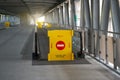 Yellow fence with a brick sign, passage is prohibited on a travelator, an elevated pedestrian crossing at the airport Royalty Free Stock Photo