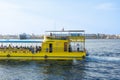 Yellow ferry boat on calm blue water Royalty Free Stock Photo