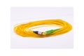 Yellow fiber optic cable rolled on white background, long network cable for data and internet connection Royalty Free Stock Photo
