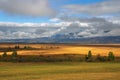 Yellow fields, clouds and mountains. Royalty Free Stock Photo
