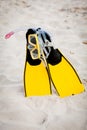 Yellow fins and snorkelling mask on beach in summer Royalty Free Stock Photo