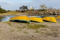 Yellow fishing boats lie on the sand by the river Royalty Free Stock Photo