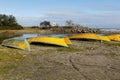 Yellow fishing boats lie on the sand by the river, Iran Royalty Free Stock Photo