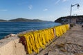 Yellow fishnet drying in the sunlight in harbour Royalty Free Stock Photo