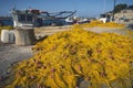 Yellow fishnet laying on a pier Royalty Free Stock Photo