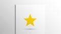 A yellow five pointed star is centered on a white square paper Royalty Free Stock Photo