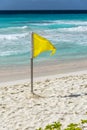 Yellow flag on a Barbados beach. Royalty Free Stock Photo