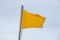 Yellow flag on the beach Royalty Free Stock Photo