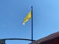 Yellow flag on the beach - indicates that a lifeguard is present. The roof is visible Royalty Free Stock Photo