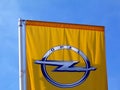 Yellow flag detail with blue sky background and OPEL car brand logo Royalty Free Stock Photo