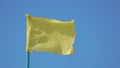 Yellow flag flutters in the wind