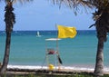 Yellow Flag Flying at Las Cucharas Beach Costa Teguise Royalty Free Stock Photo