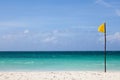 Yellow flag stands on the beach. Royalty Free Stock Photo