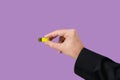 Yellow flash drive on hand with isolated violet background