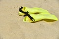 Yellow flippers for scuba diving lie on the sand Royalty Free Stock Photo
