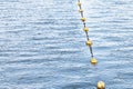 Yellow float floats on a rope floating in the sea Royalty Free Stock Photo