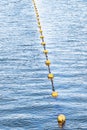 Yellow float floats on a rope floating in the sea Royalty Free Stock Photo