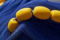 Yellow floats on a rope with blue nets Royalty Free Stock Photo